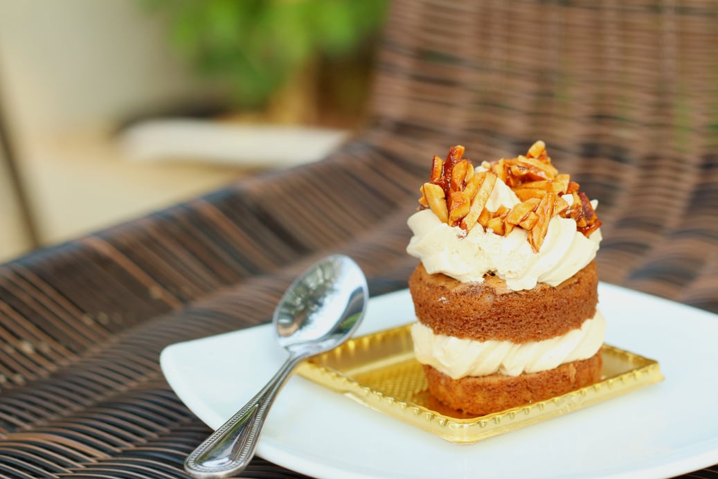 tiramisu with spoon on a white plate